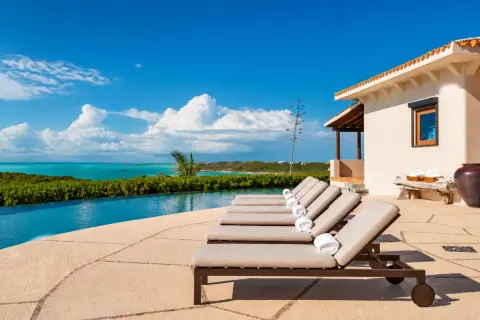 An infinity pool and private villa terrace overlooking the sea